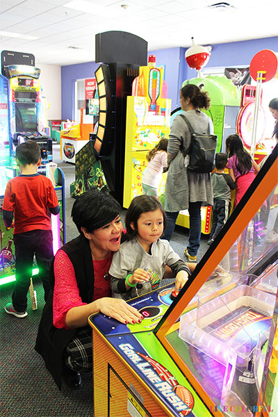 mother and child playing game at chuck e cheese