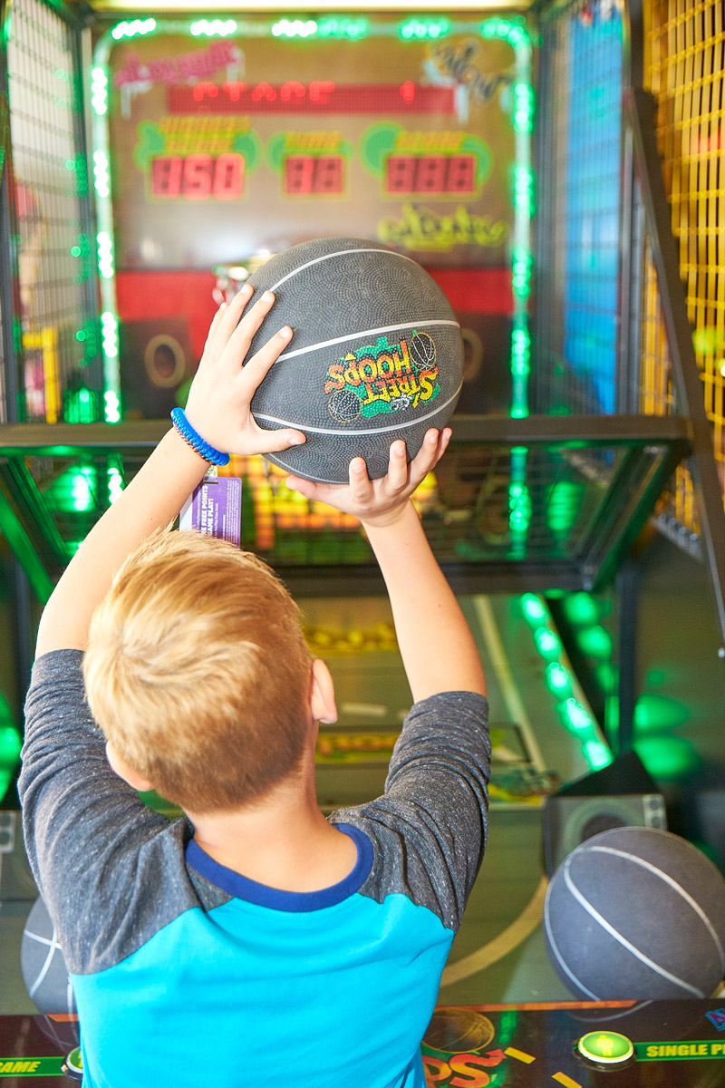 Kid about to shoot a basketball in arcade