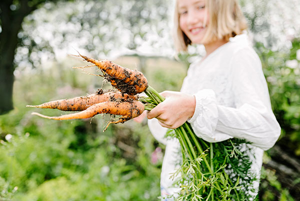 Girl holding carrots