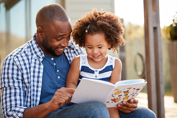 Dad reading to daughter