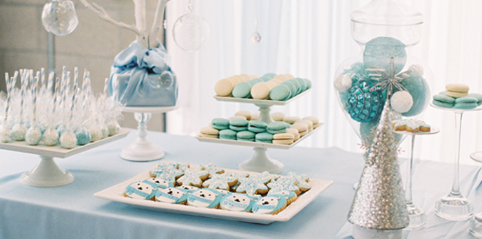 Winter wonderland birthday supplies. Penguin cookies, blue and white cookies, cake pops