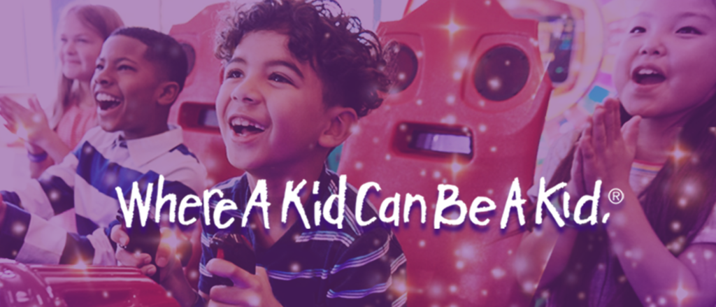 image of 4 kids playing game smiling with text that reads "where a kid can be a kid"
