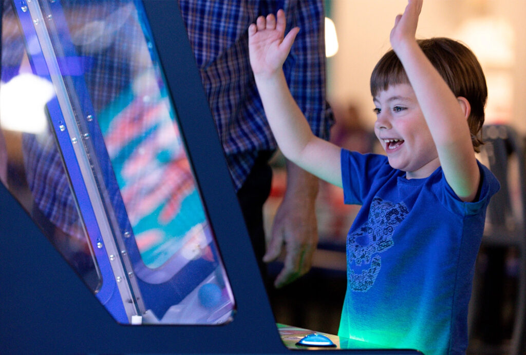 Kid cheering while playing a game