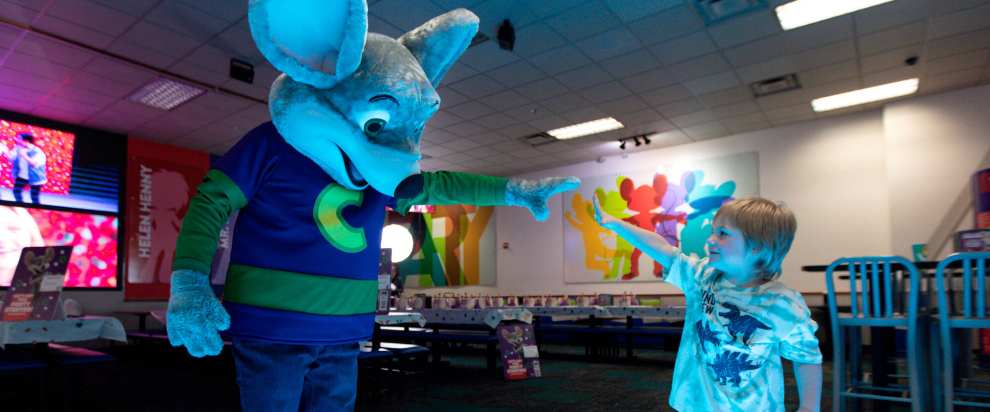 Chuck E. and Kid reaching to each other