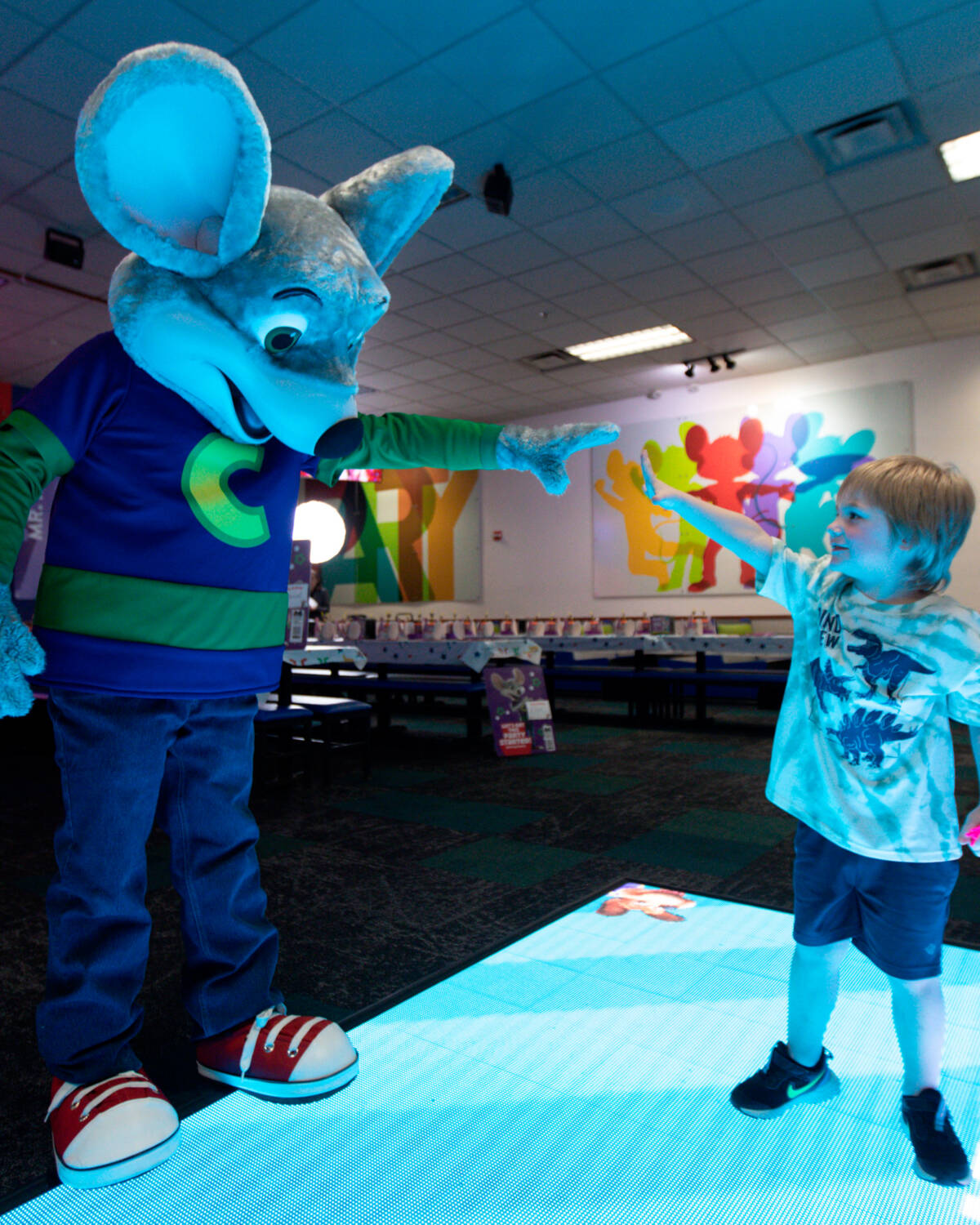 Chuck E. and Kid reaching to each other