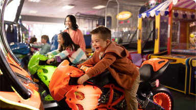 kids riding motorcycle games in the arcade