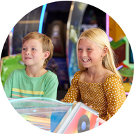 brother and sister playing arcade game together