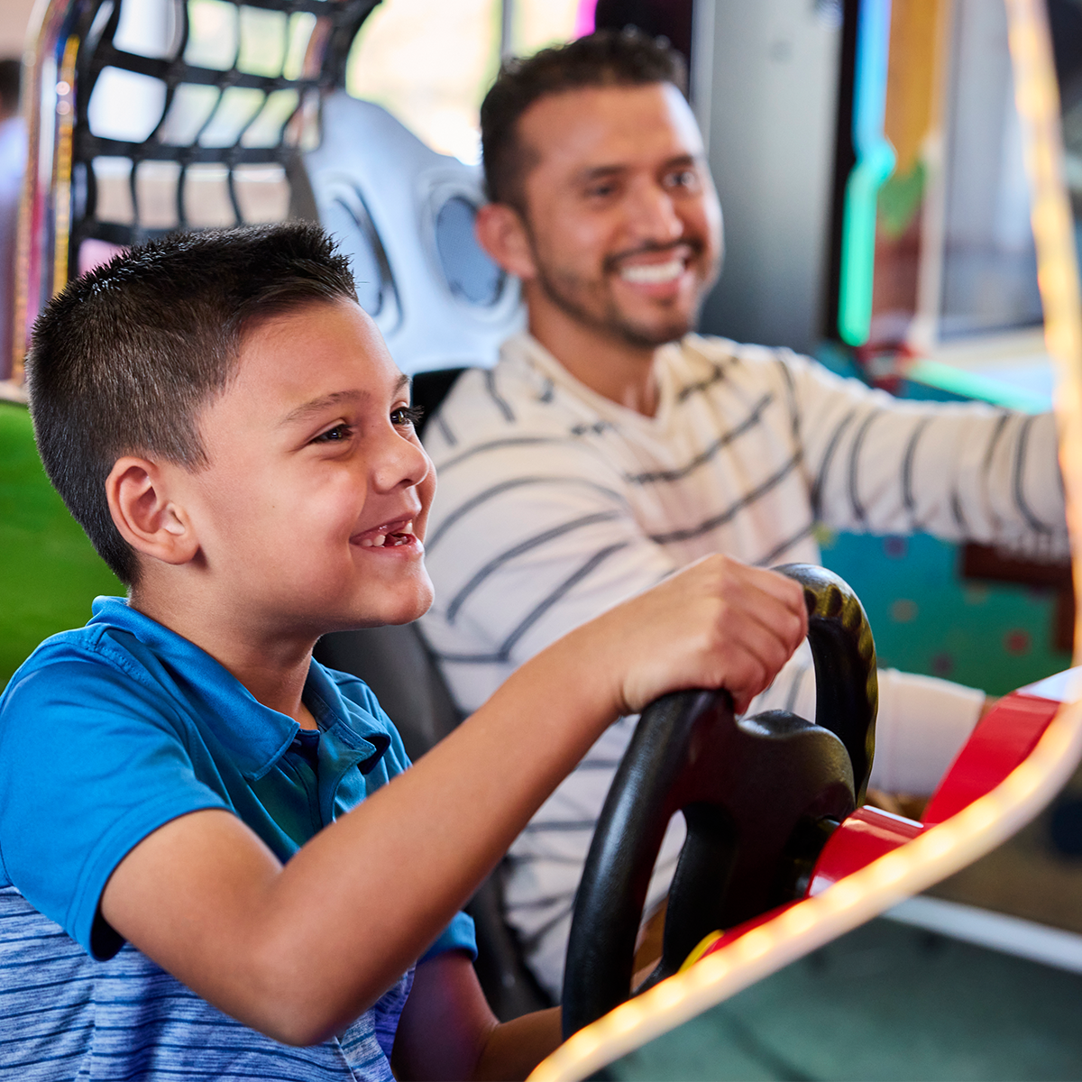 kid and dad playing race car game