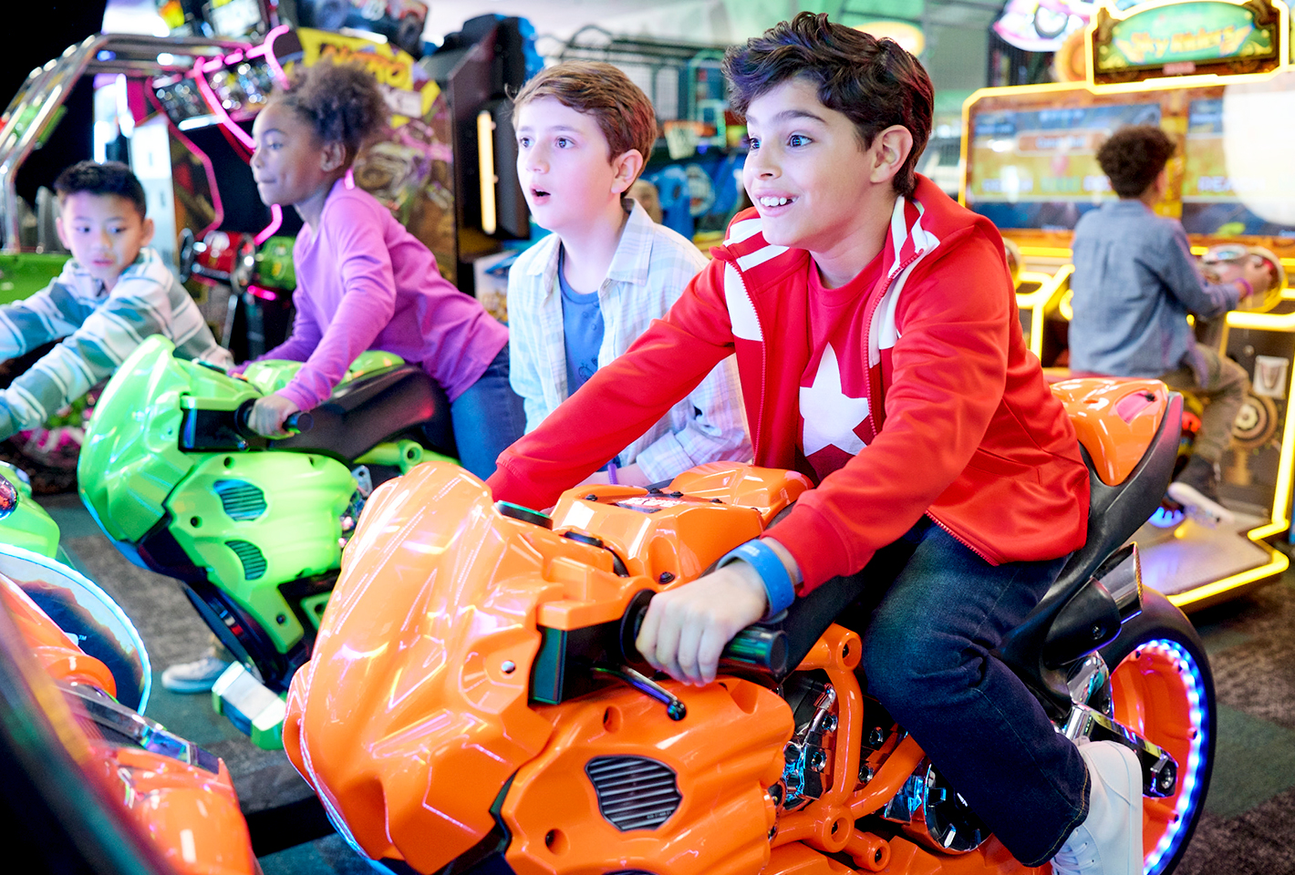 A group of kids playing the motorcycle race game