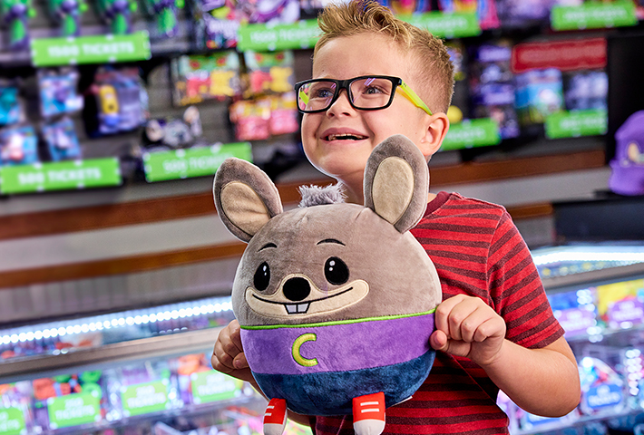 young child holding chuck e cheese prize