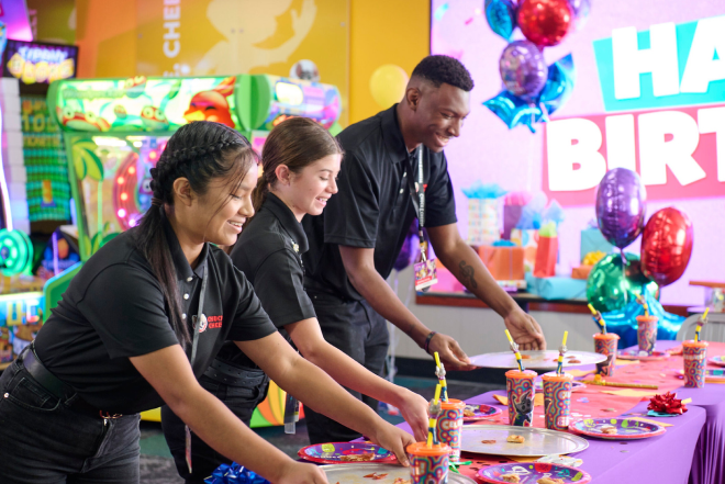 Chuck E. cheese cast members cleaning up after birthday party.