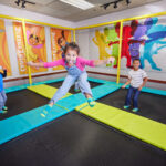 young kids jumping on trampolines