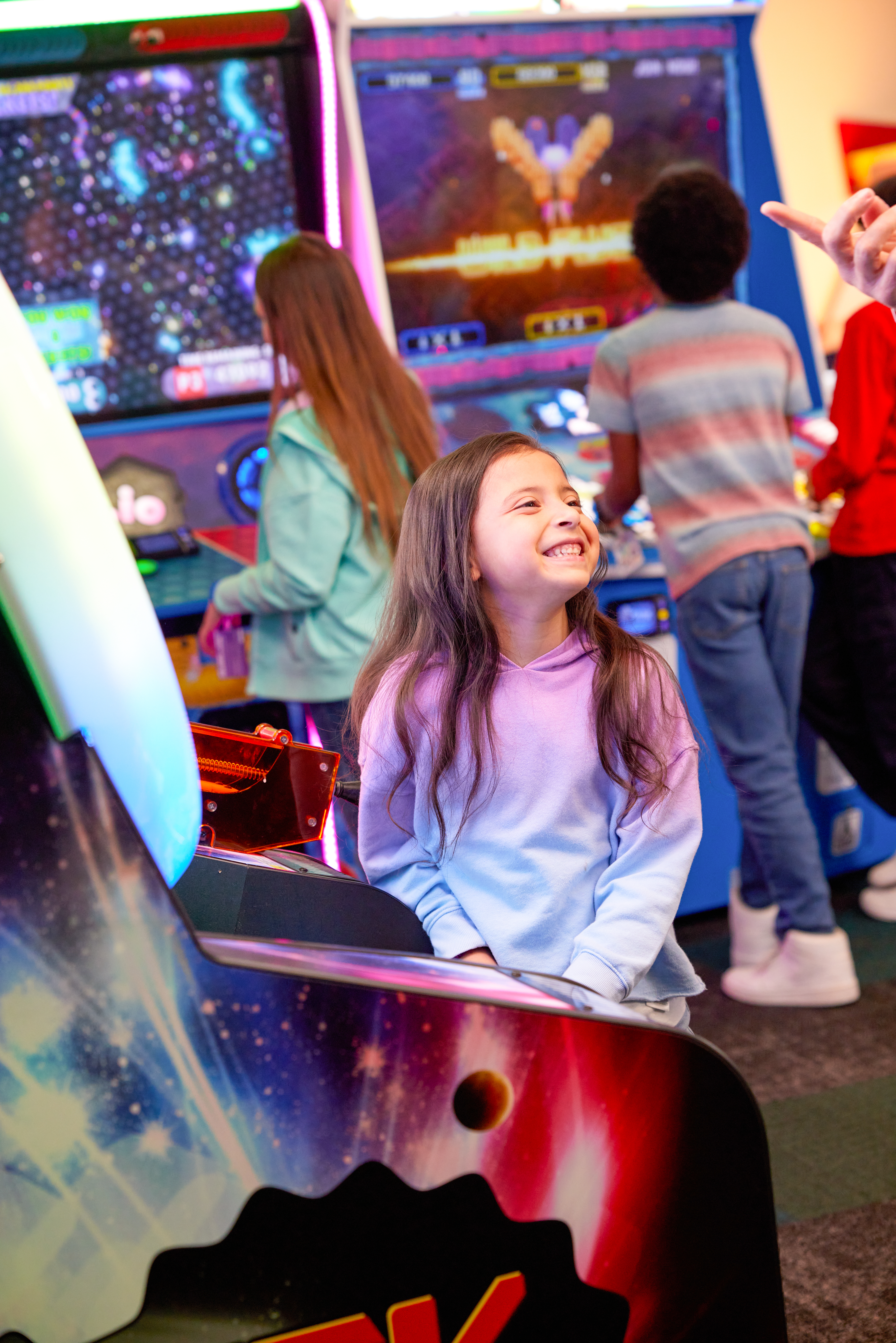 young girl playing arcade games