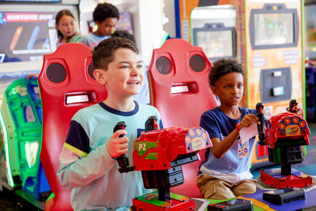 young boys playing arcade games