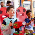 young boys playing arcade games