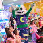 chuck e. cheese throwing confetti at kids birthday party