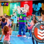 chuck e. cheese having a dance party with kids at chuck e. cheese