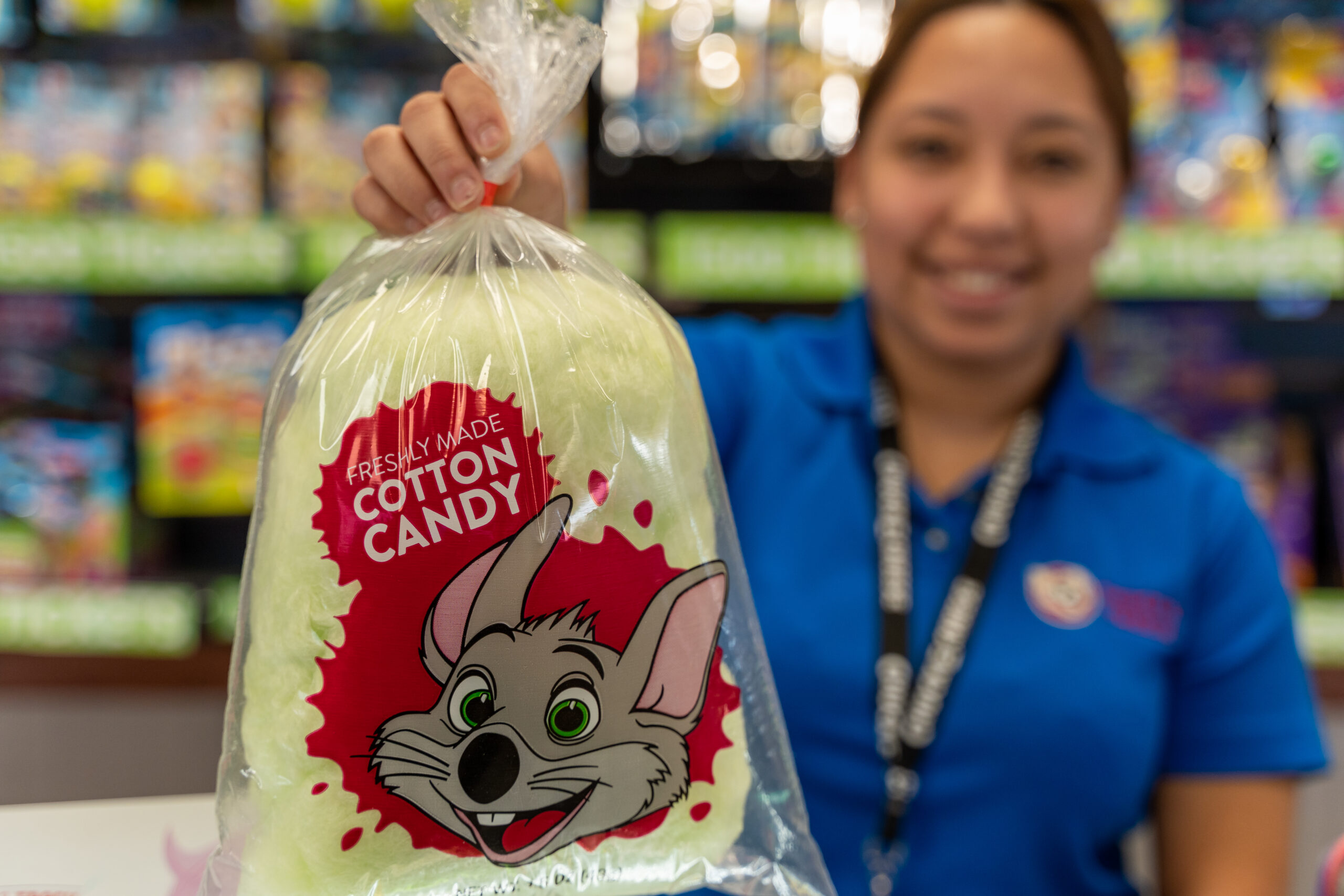 Cast member holding a bag of cotton candy.