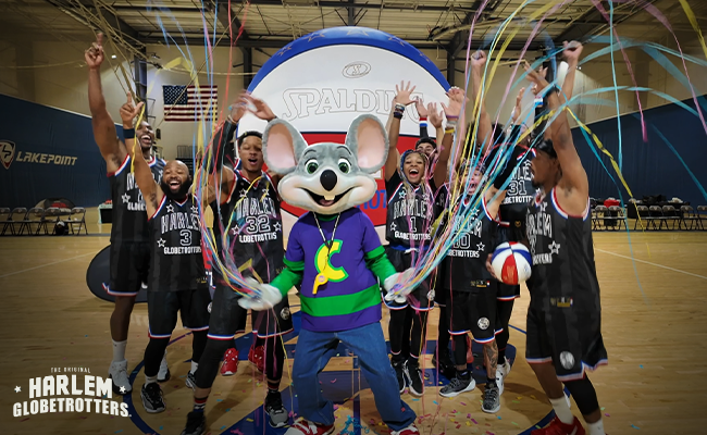 chuck e. standing with the harlem globetrotters