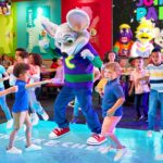 Children dancing with Chuck E. Cheese.