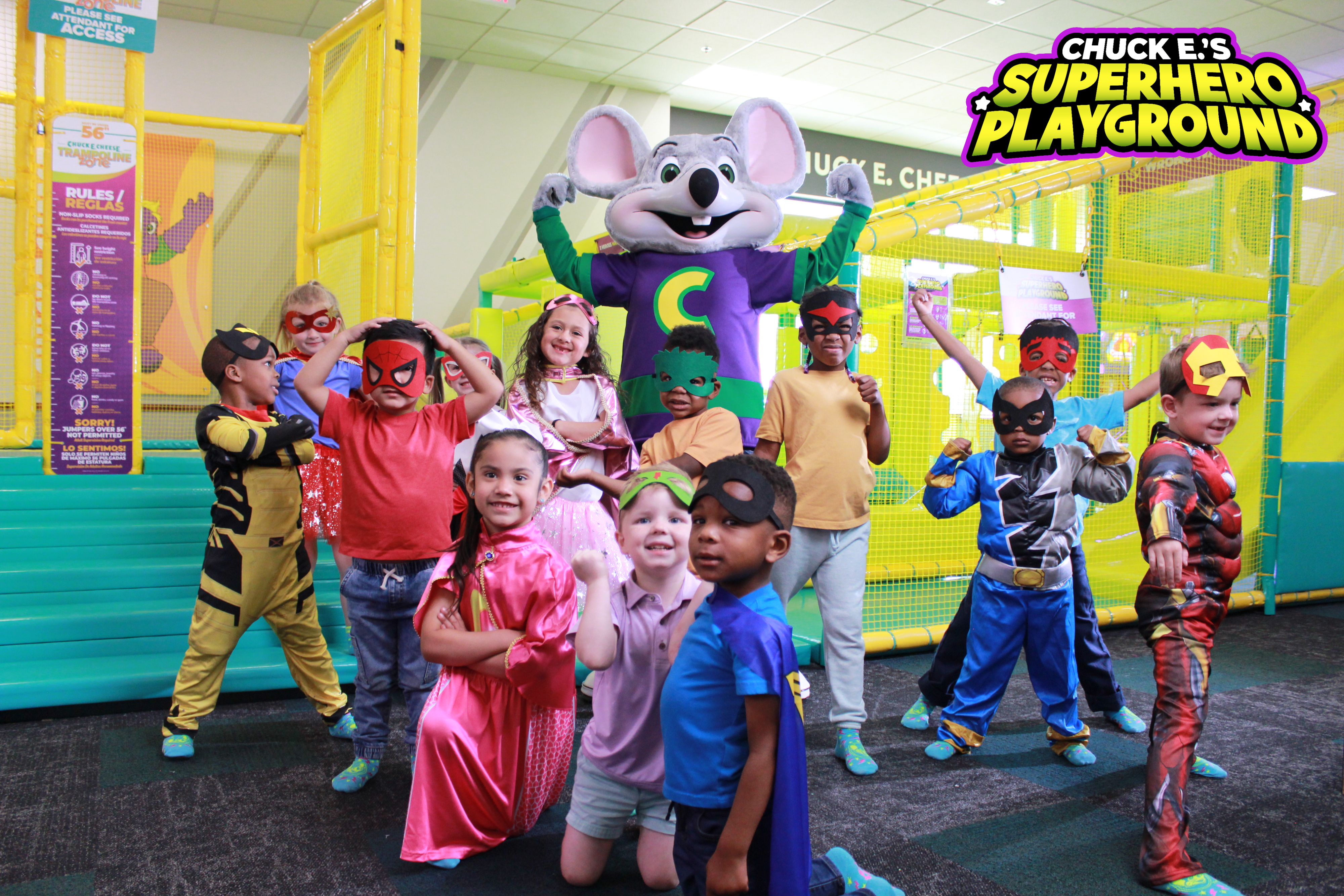 Children in superhero costumes with Chuck E. Cheese at the Superhero Playground