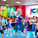 Chuck E. Cheese and kids dancing on dance floor