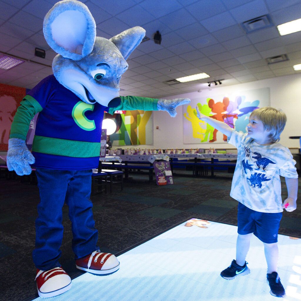 Child interacting with mascot character