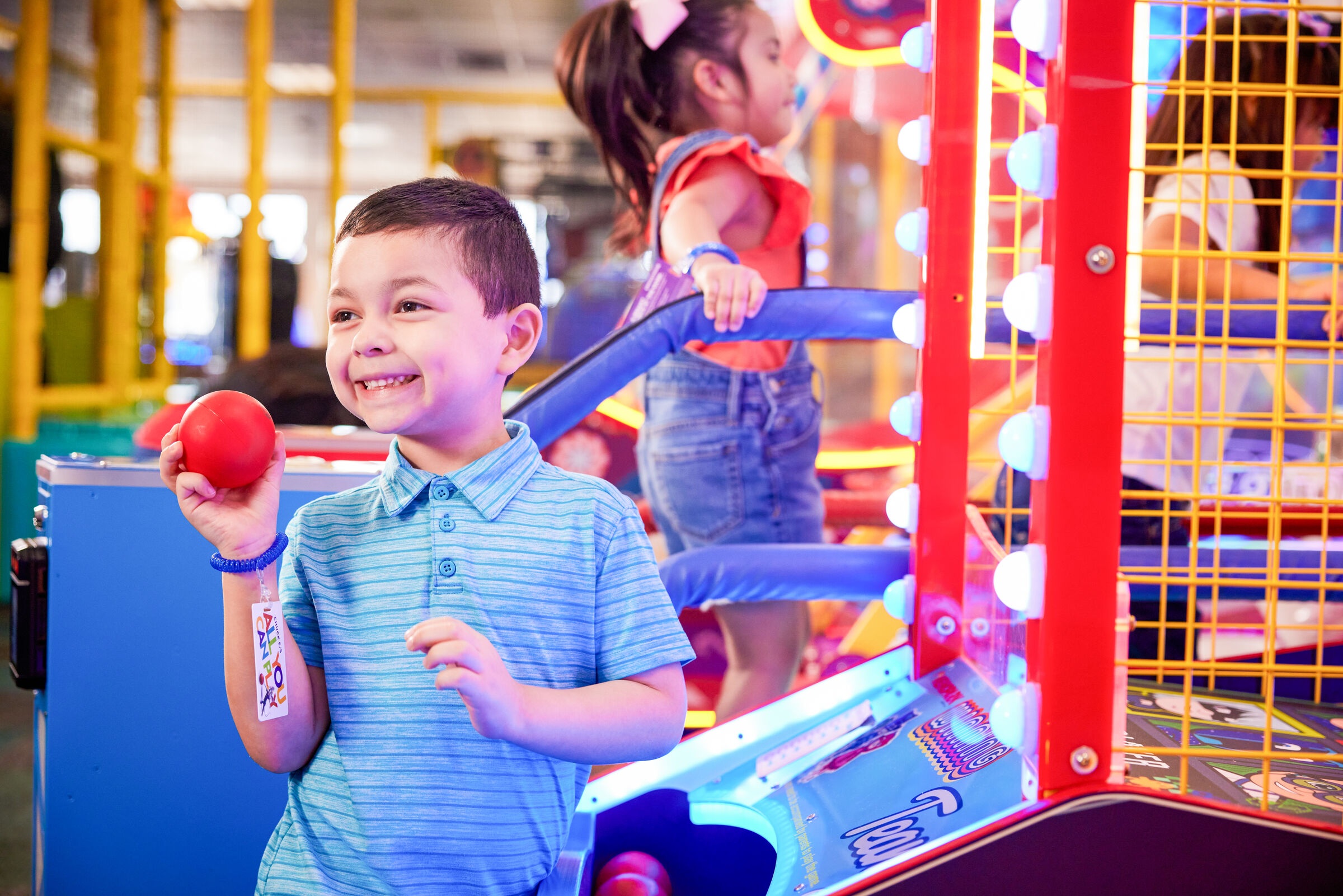 Young boy focused on an arcade game at Chuck E. Cheese