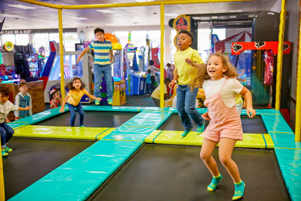 Kids enjoying the Adventure Zone at Chuck&nbsp;E.&nbsp;Cheese — Trampoline Zone and Superhero Playground for kids under 56 inches