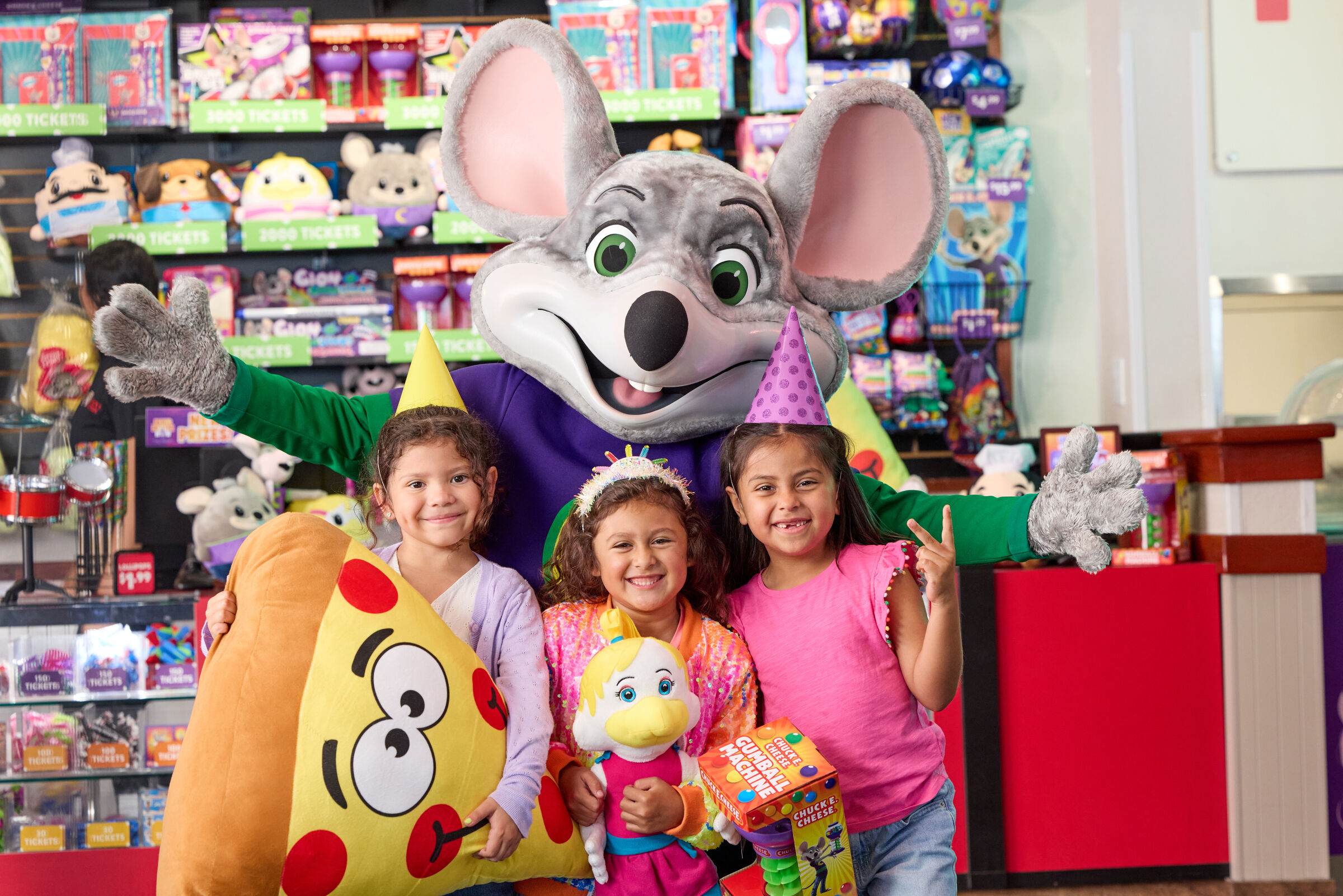 Kids at Chuck E. Cheese birthday party holding prizes
