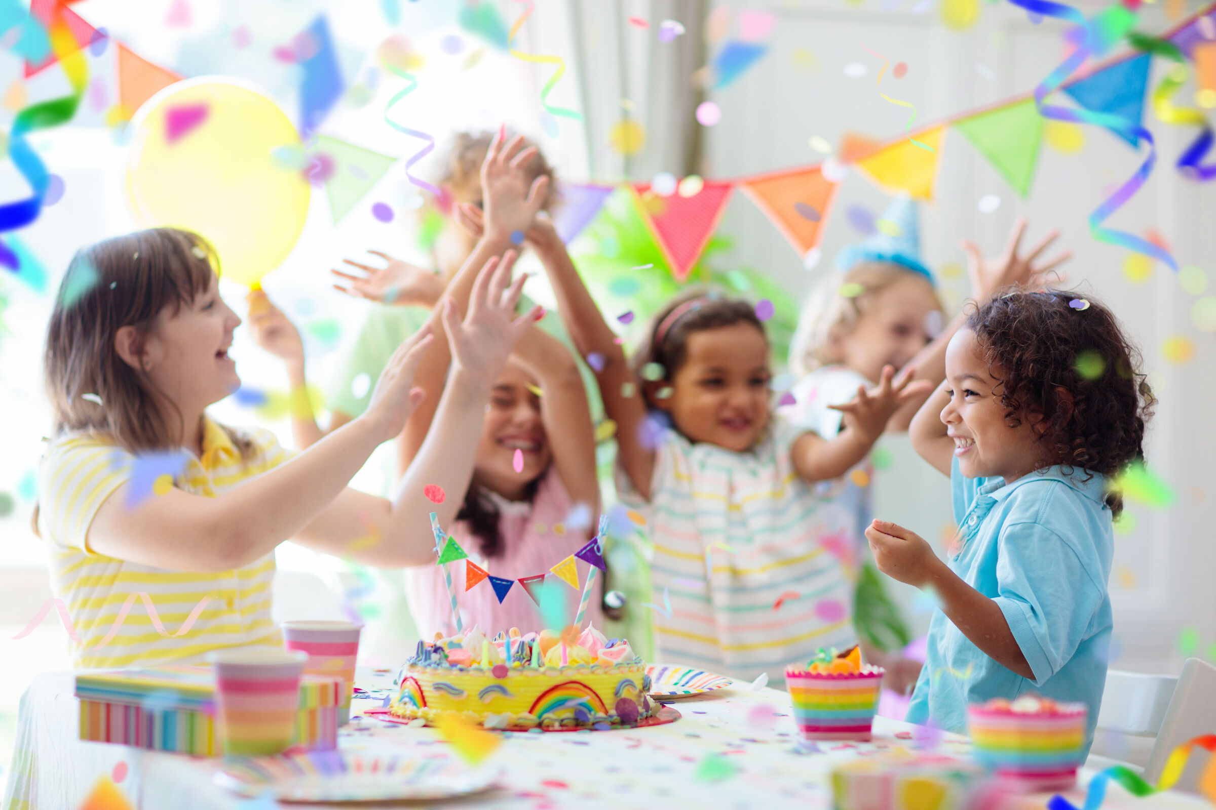 Kids ages 5–8 celebrating a birthday party at Chuck E. Cheese with cake and decorations