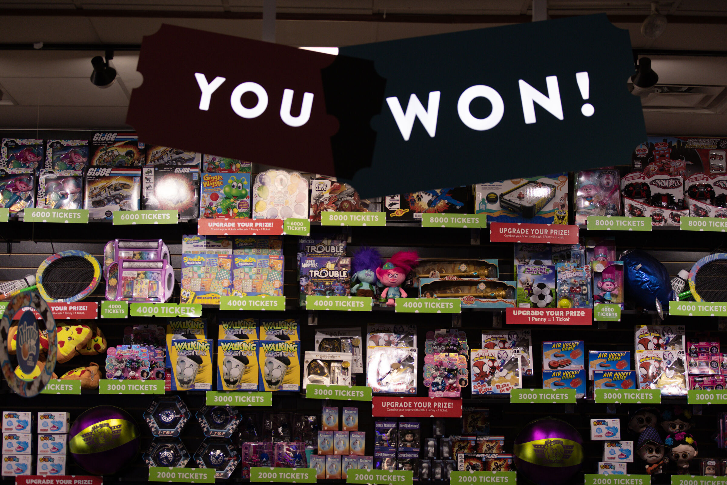 Prize counter at Chuck E. Cheese with a YOU WON sign during Sensory Sensitive Sundays