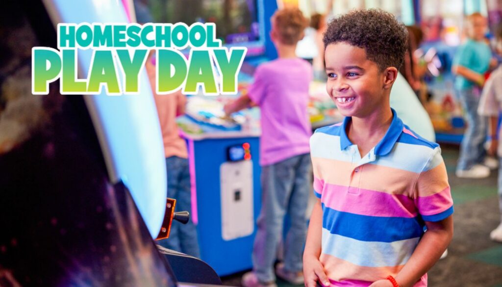 Smiling boy with missing front teeth enjoying a homeschool play day at Chuck E. Cheese arcade.