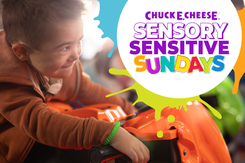 Smiling child playing an arcade game during a Sensory Sensitive Sundays event at Chuck E. Cheese.