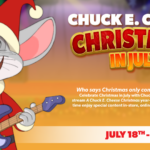 Chuck E. Cheese in a Santa hat playing a guitar, promoting Christmas in July.